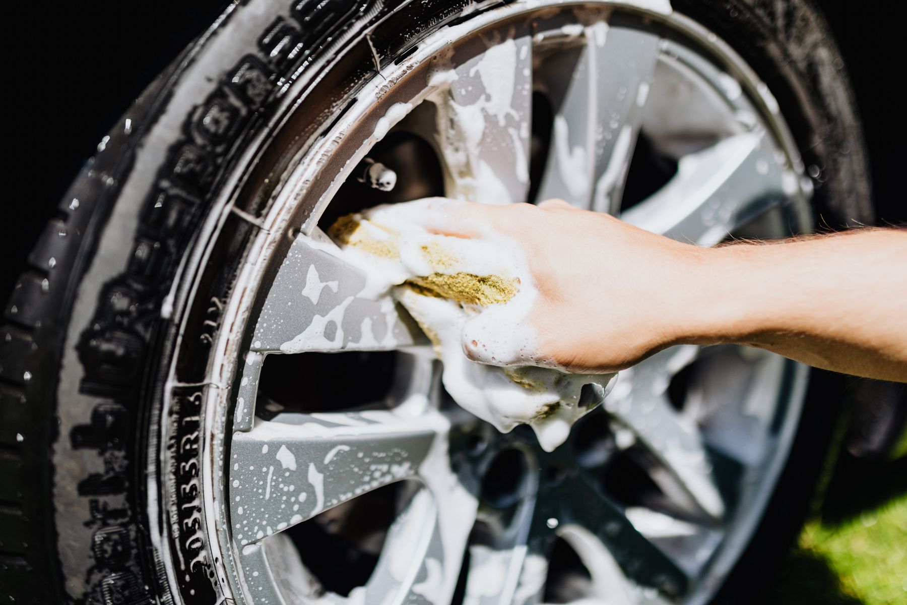 A vehicle wheel covered with cleaning foam